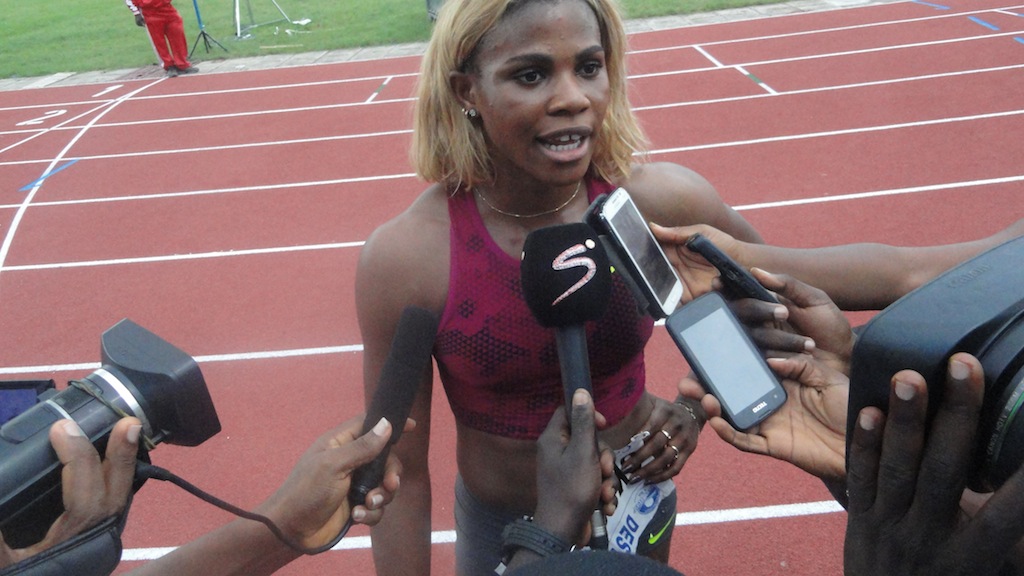 Okagbare is mobbed by Nigerian media and fans alike following her 100m win at the Nigerian Trials