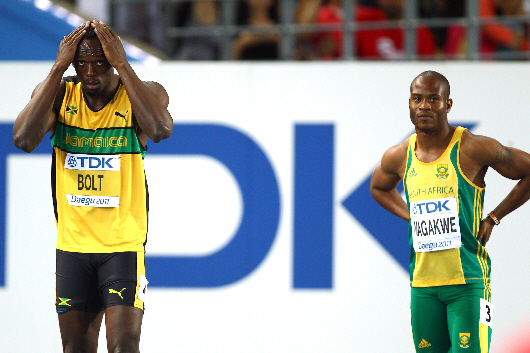 Simon Magakwe lining up against Usain Bolt at the 2011 World Championships. Magakwe is the fastest African so far in 2014, joining the sub-10 sprinters club with a new PB of 9.98 seconds