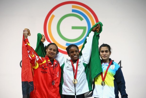 (L-R) Silver medalist Dika Toua of Papa New Guinea, Gold medalist Chika Amalaha of Nigeria and Bronze medalist Santoshi Matsu of India after the Women's 53kg Group A Weightlifting  (Photo by Julian Finney/Getty Images)
