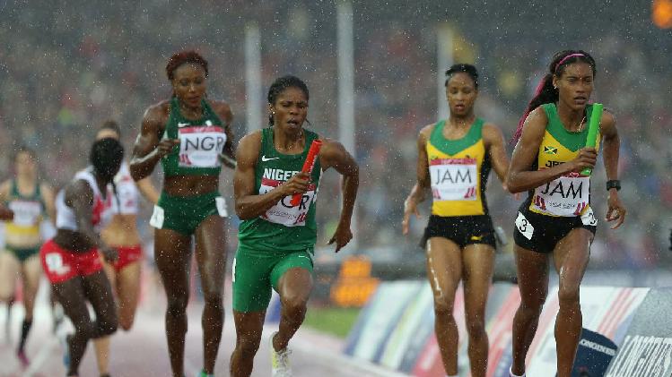 Folashade Abugan, 400m Nigerian Champion, after receiving the baton from Ada Benjamin  for the last leg of the women's 4x400m at Hampden Park in Glasgow at the 2014 C'wealth Games.  Jamaica won the GOLD, with Nigeria getting the Silver and England the Bronze!  (Photo Credit: AP Photo/ Scott Heppell)