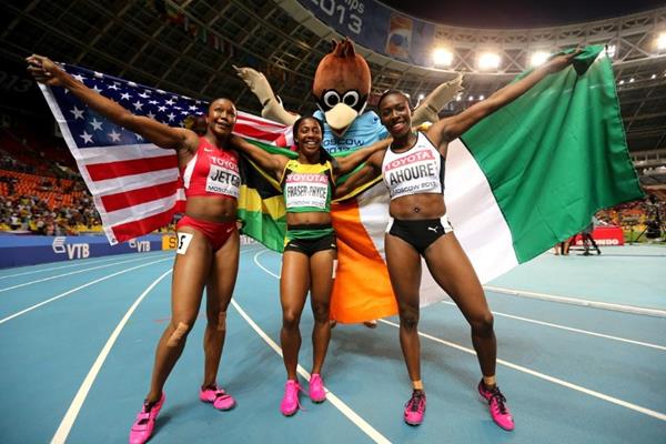 Murielle Ahoure celebrates her 2013 World Championships Silver medal along with 100m champion, Shelly-Ann Fraser-Pryce and bronze medallist, Carmelita Jeter of the US.  (Photo Credit: Getty Images).