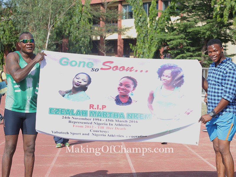 Deji Aliu and Fred Agbaje holding a banner in honour of Nkem Ezealah.