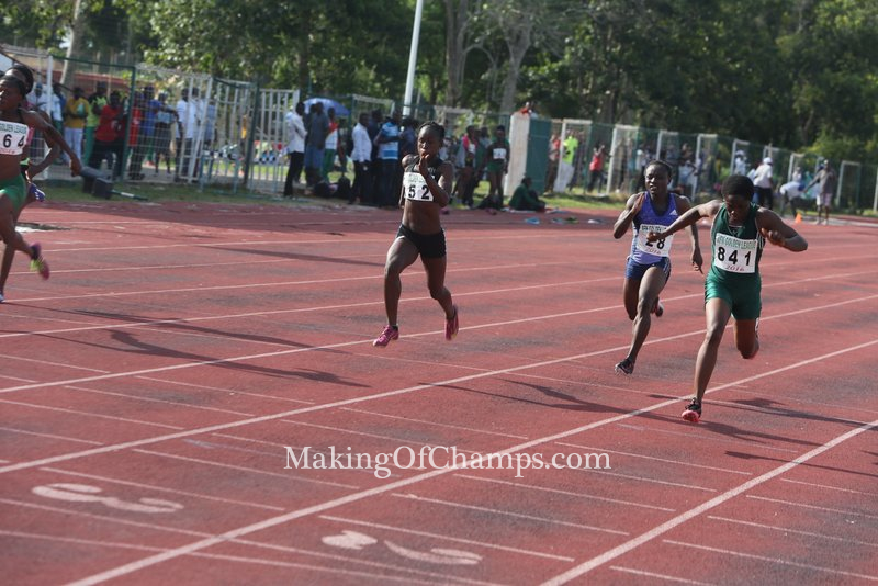 MoC's Joy dipping in first to win the women's 100m B final.